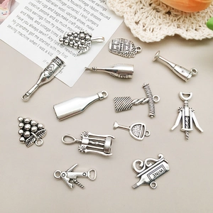 Detailed view of antique silver wine-themed alloy charms including bottle and barrel