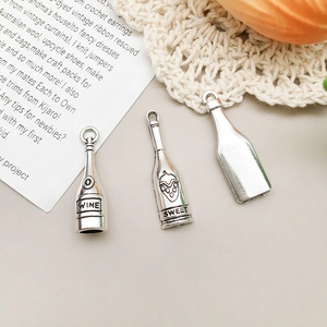 Macro detail of antique silver wine bottle charms with WINE and SWEET engravings for DIY