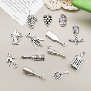 Detail of vintage silver wine-themed charms including bottles and grape bunches