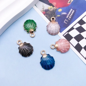Macro shot of colorful shell pendants in alloy with glitter drip oil finish for DIY
