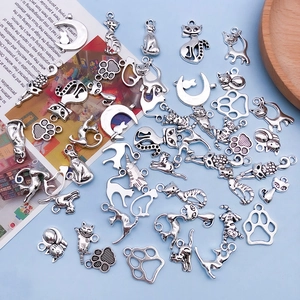 Detailed view of silver antique cat and paw alloy charms for DIY jewelry crafting