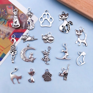 Detailed macro view of 15 unique antique silver cat and paw print DIY alloy charms