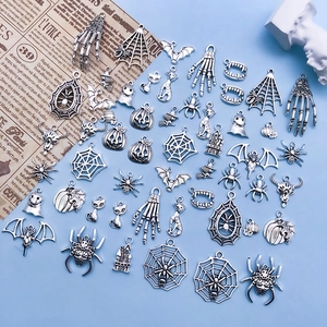 Detailed macro view of vintage silver Halloween alloy charms featuring spiders and bats