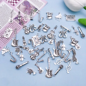 Macro view of antique silver music instrument charms including guitar and violin