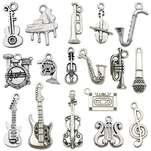 Antique silver musical instrument alloy pendants set with guitars, violins and music notes