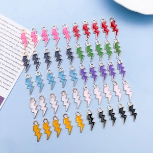 Flat lay of colorful lightning bolt enamel charms for DIY jewelry making accessories