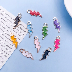 Detailed flat lay of colorful enamel lightning bolt charms with gold metal edges