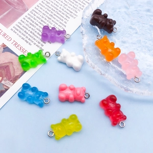 Macro shot of colorful resin gummy bear charms with metal loops for DIY jewelry making