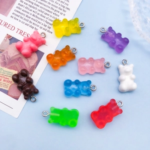 Close-up of colorful resin gummy bear charms with metal rings for DIY jewelry making