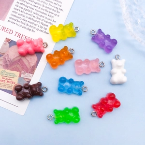 Close-up of colorful resin gummy bear charms with silver jump rings for jewelry making