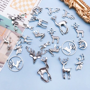Detailed view of assorted antique silver deer alloy pendants for DIY jewelry making