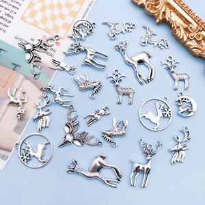 Detailed view of vintage silver deer charms and reindeer pendants for DIY jewelry making