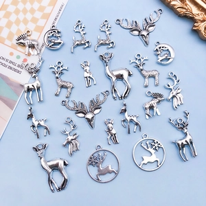 Macro view of vintage silver alloy deer pendants for DIY jewelry and Christmas ornaments