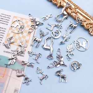 Detailed close-up of vintage silver elk alloy charms for DIY handmade jewelry crafts