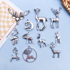 Detailed overhead view of 11 vintage silver alloy deer charms for DIY jewelry making