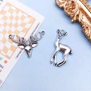 Detail of antique silver deer alloy pendants for DIY jewelry and Christmas elk charms