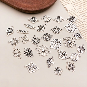 Detailed macro of antique silver hollow rose flower pendants for DIY jewelry making