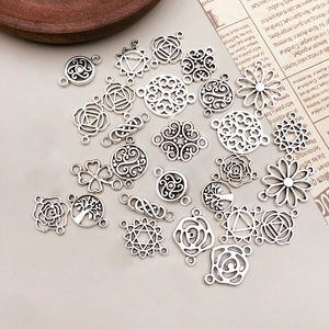 Detailed view of antique silver alloy floral pendants and chakra charms for DIY jewelry making