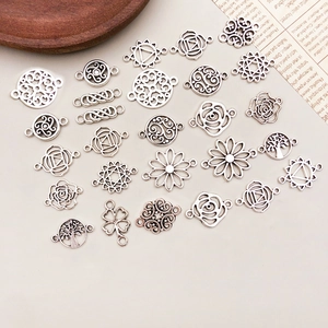 Detailed close-up of antique silver hollow rose flower alloy charms for DIY jewelry