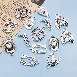 Macro detail of vintage silver cowboy hat and boot alloy charms for DIY jewelry