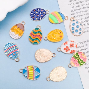 Macro detail of colorful Easter egg charms with various drip oil patterns and gold alloy loops