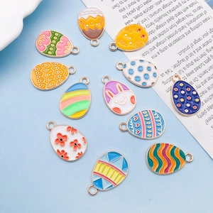 Detailed view of 11 colorful Easter egg charms with bunny and floral enamel patterns