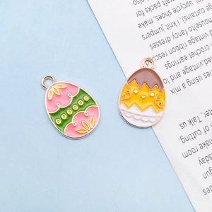 Detailed close-up of Easter egg and yellow chick enamel alloy charms for DIY jewelry