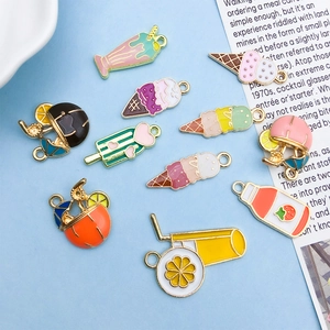 Detailed macro view of colorful enamel summer fruit and ice cream alloy charms for DIY crafting