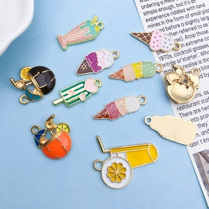 Detail view of colorful enamel summer fruit and ice cream charms for DIY jewelry making