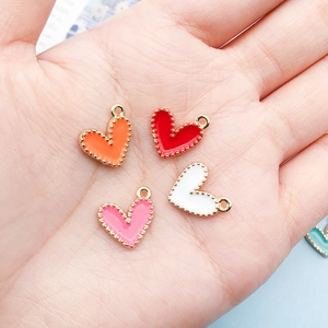 Detail of colorful enamel heart charms with gold beaded edges for DIY jewelry making
