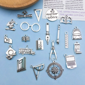 Antique silver graduation themed alloy charms set featuring graduation caps and school buses