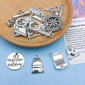 Detailed set of silver educational charms including school bus, books and graduation caps