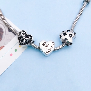Detail of silver snake chain bracelet with Be My Valentine heart and bow charms