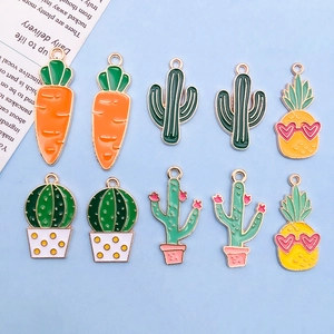 Flat lay of 10 mixed cartoon alloy charms including cactus and pineapple pendants