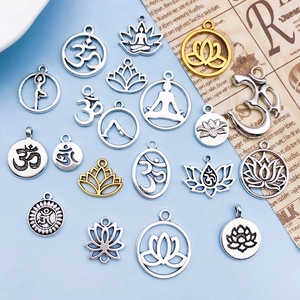 Assorted yoga lotus and Om symbol alloy pendants in antique gold and silver finishes