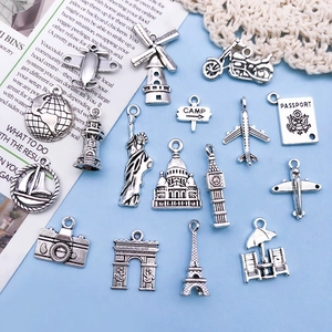 Set of vintage silver alloy travel charms including Eiffel Tower and airplane for jewelry