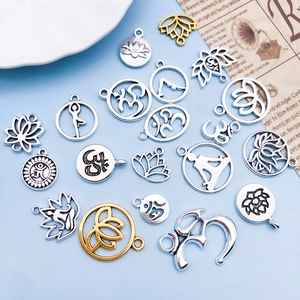 Detailed collection of vintage silver yoga lotus pendants and Om symbols for jewelry making