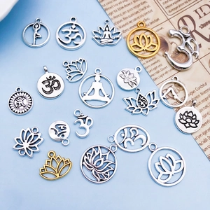 Detailed flat lay of gold and silver Om lotus yoga charms for DIY jewelry making