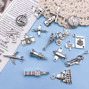 Macro shot of vintage silver travel charms featuring landmarks like the Eiffel Tower