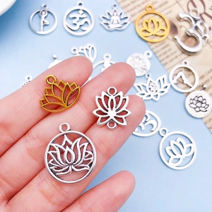 Macro detail of mixed antique gold and silver lotus yoga pendants for DIY jewelry making