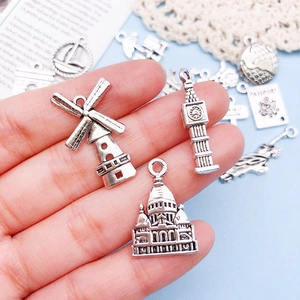 Detailed view of vintage silver travel charms featuring world landmarks for DIY jewelry