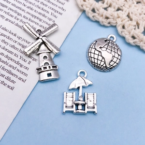 Detailed set of silver vintage alloy charms including windmill globe and beach chair