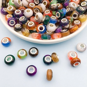 Close-up of colorful resin gradient cat-eye large hole beads with silver metal cores