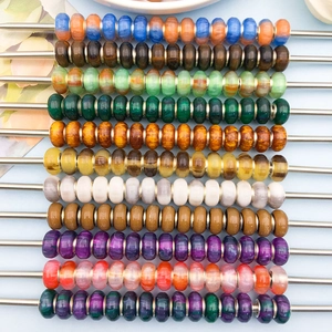 Close-up of colorful resin cat eye beads with metal core for DIY bracelet making