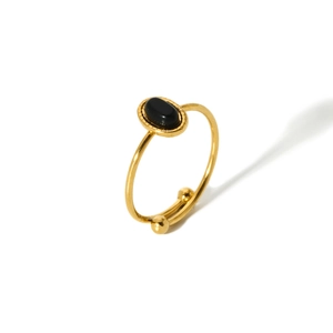 Close-up of 18K gold-plated adjustable ring with oval black stone and vintage texture