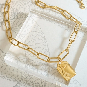 Three-layer irregular gold necklace with paperclip chain and portrait pendant