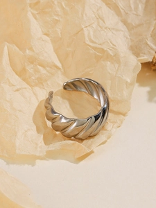 Detailed macro view of the silver ribbed twisted texture on an adjustable open ring