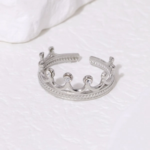 Detail of silver crown ring with cubic zirconia stones and braided rope texture