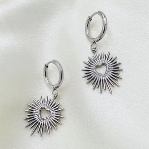 Silver stainless steel hoop earrings with sunburst heart charms on silk fabric