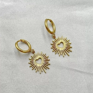 Golden stainless steel hoop earrings with sunburst charms and hollow heart center